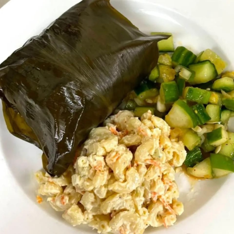 A plate of Hawaiian lau lau, macaroni salad, and cucumber salad from Menehune Coffee Company.